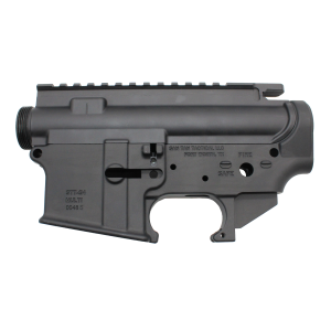 Close-up of a black firearm upper receiver with a Picatinny rail and partial markings visible on the side.